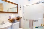 Full bathroom with shower only,  no tub is located in the queen bedroom.